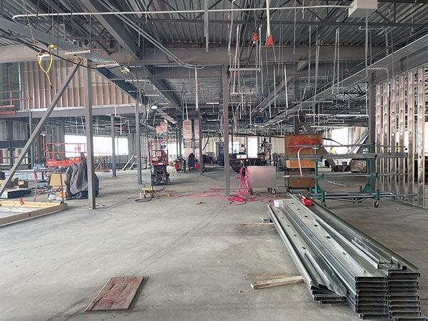 a large space under construction with some steel frames for walls