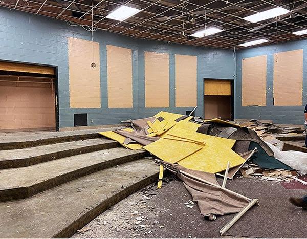 a large room with risers has construction debris in the center